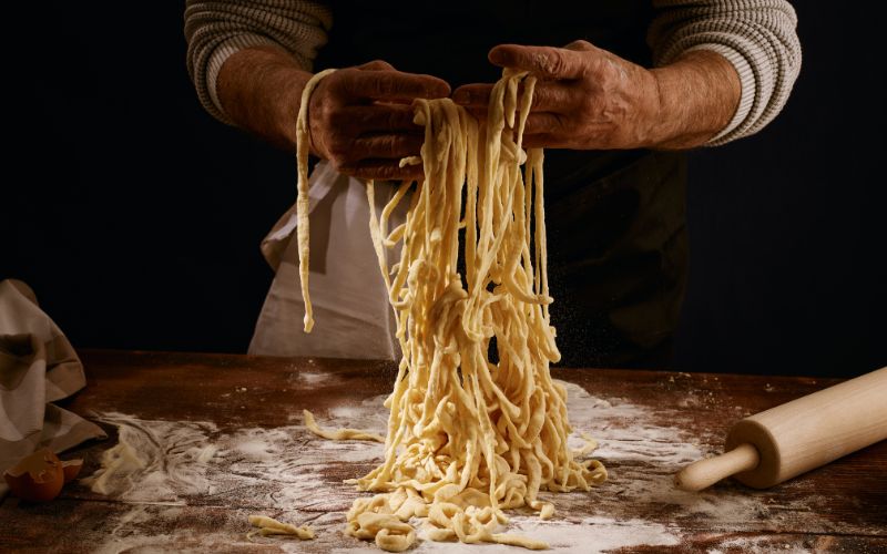Kneading fresh pasta on table